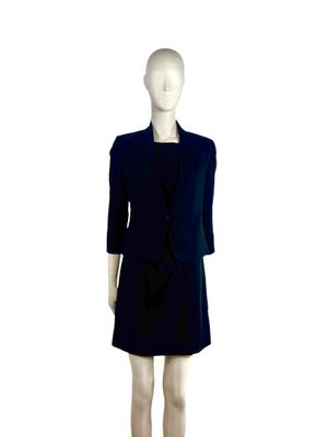 a mannequin wearing a black dress and jacket