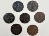 a group of five coins with the names of different countries on them