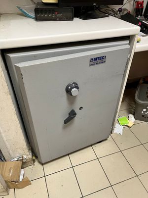 an image of a small safe box in the corner of a room