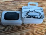 a box with a charger and a cable in it on a wooden table