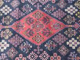 an image of a blue and red rug with a design on it