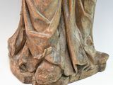 statue of a woman holding a vase of flowers on a white surface