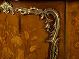 a wooden cabinet with a marble top and a floral design on it