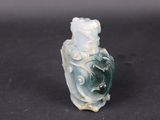 an old jade carved bottle with a dragon on it