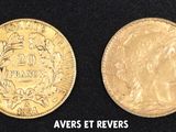 four different types of gold coins on a black surface