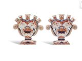 pair of vases with floral designs on each side of them