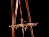 a wooden easel that is standing up against a black background