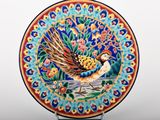 a decorative plate with a bird painted on it