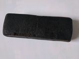 a close up of a small black object on a white surface