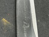 a knife that is laying on the ground on the ground