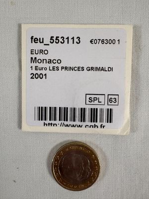une pièce de monnaie sur laquelle figure un code-barres, à côté d'un autre code-barres