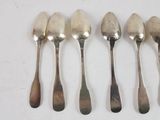six spoons are lined up in a row on a white surface