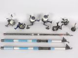 several different types of fishing rods and reels laid out on a white surface