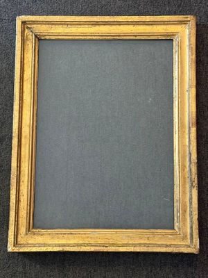 an old picture frame with a black background and gold trim