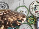 many plates and bowls on a table with a white table cloth