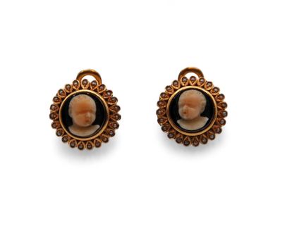 an image of a pair of earrings with a picture of a woman