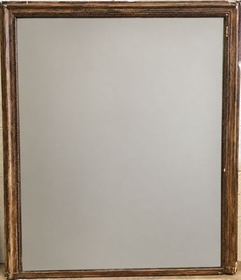 a large mirror with a gold frame and a silver background