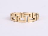 a close up of a gold ring on a white surface
