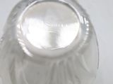 underside view of a clear glass vase with a white background