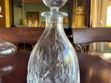 a glass bottle sitting on a table in a room