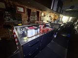 a kitchen with a sink and a counter with a lot of items on it