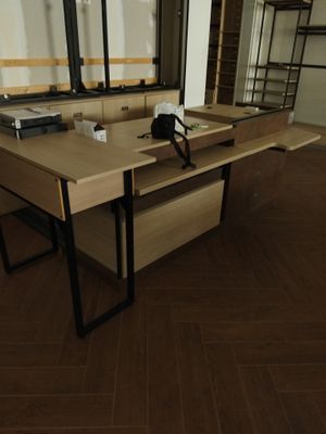 a desk with a mirror and a phone on it in a room