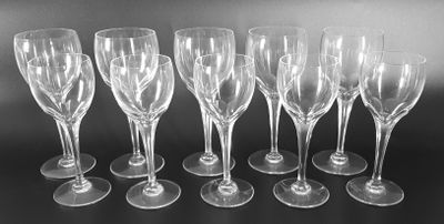 six empty wine glasses lined up in a row on a table