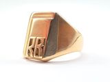 an image of a gold signet ring with a monogram on it