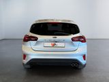 the rear end of a white ford fiesta parked in a white room