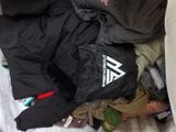 a bag full of clothes and a stuffed animal in it
