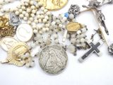 a lot of religious items that are laying on a table