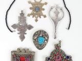 several different types of jewelry are displayed on a white surface