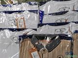 a lot of t - shirts that are wrapped in plastic