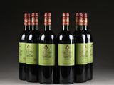 four bottles of red wine are lined up in a row