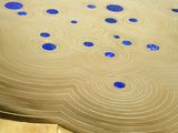 a close up view of a wooden table with blue dots on it