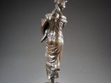 an image of a bronze statue of a woman holding a bird