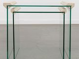 a glass table with a wooden base and a clear glass top