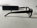 glasses on a white table with a pair of glasses in the background