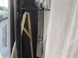 a birdcage on a stand in front of a window