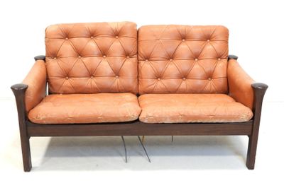 a brown leather couch that is sitting on a white floor