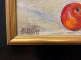 a painting of a red apple in a gold frame