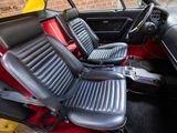 a picture of the interior of a car with red and black seats