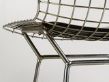 a metal chair with a black seat on a white background