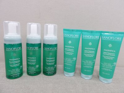a group of four bottles of skin care sitting next to each other