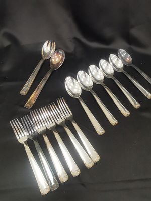 a lot of silver spoons and spoons on a table