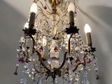 a chandelier that has a lot of crystal hanging from it
