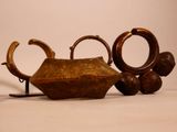 a brown teapot sitting on a table next to two other teapots