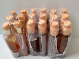several bottles of honey are wrapped in plastic bags on a table