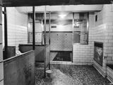 black and white photograph of a bathroom with a toilet and a sink