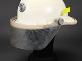a close up of a white hard hat on a black base